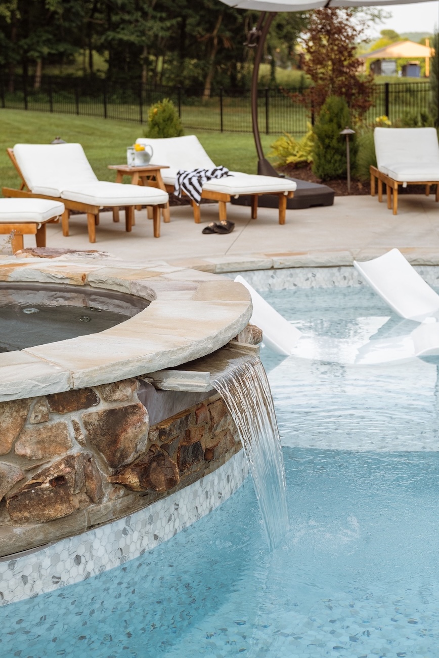 Custom Pool, Spa with Waterfall, White Pool Floats, White Patio Chairs | Milosi Nashville Landscaping