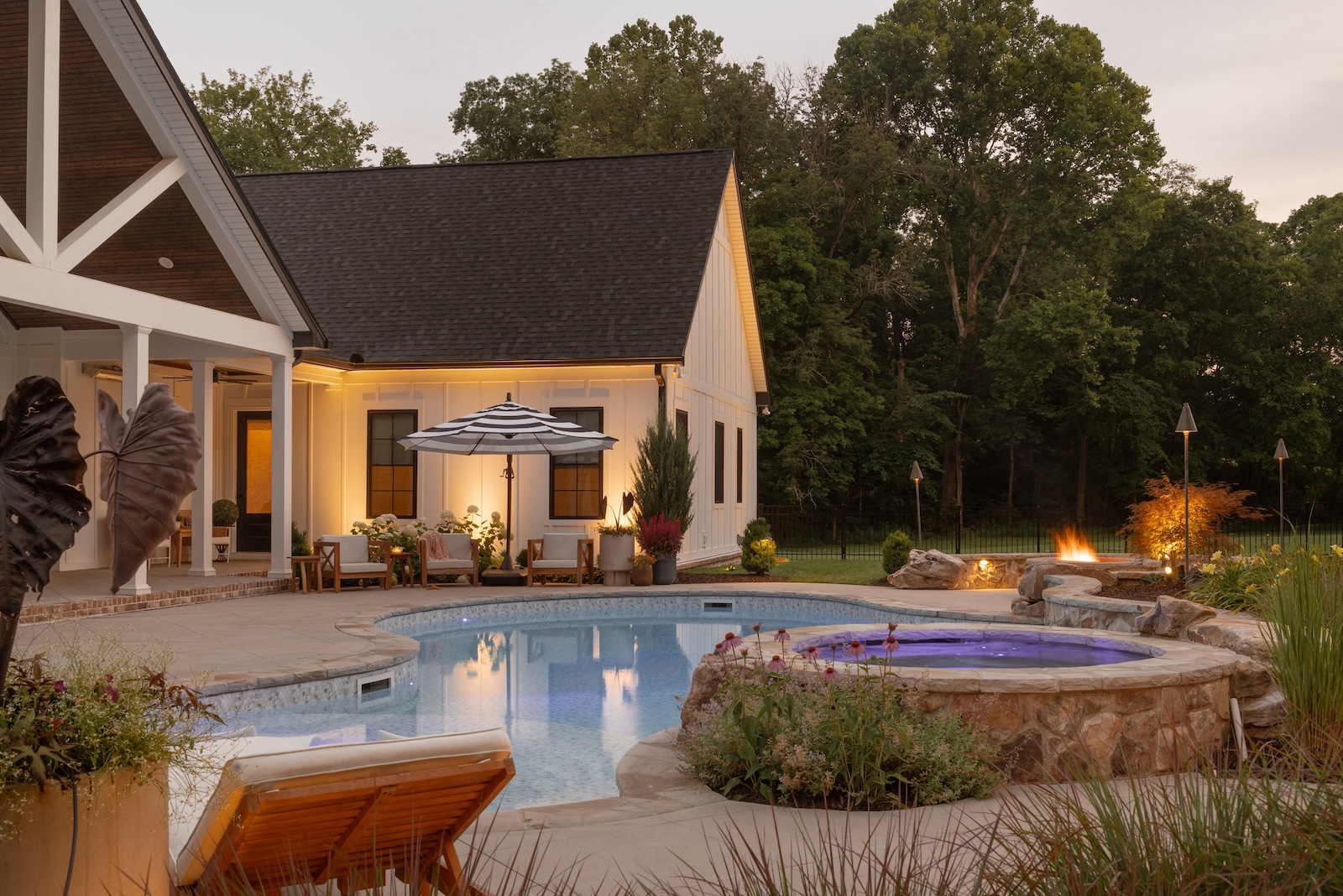Custom Pool & Spa with Lush Landscaping, Artful Lighting, Patio & Hardscapes | Milosi Nashville Landscaping