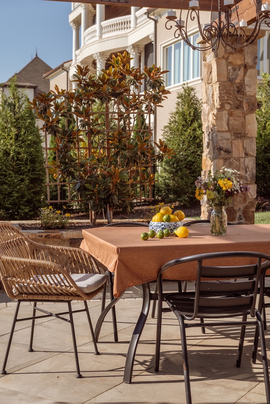 Custom Outdoor Living with Climbing Trellis and Fruit-Adorned Table, Flowers, Chairs | Milosi Nashville Landscaping