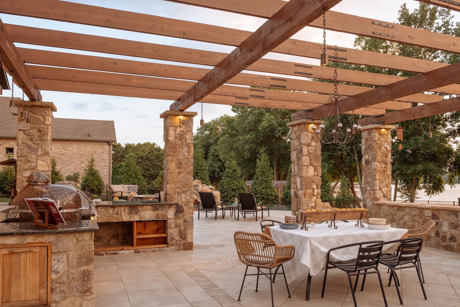 Custom Outdoor Kitchen in Stone, Granite, with Seating, Table | Milosi Nashville Landscaping