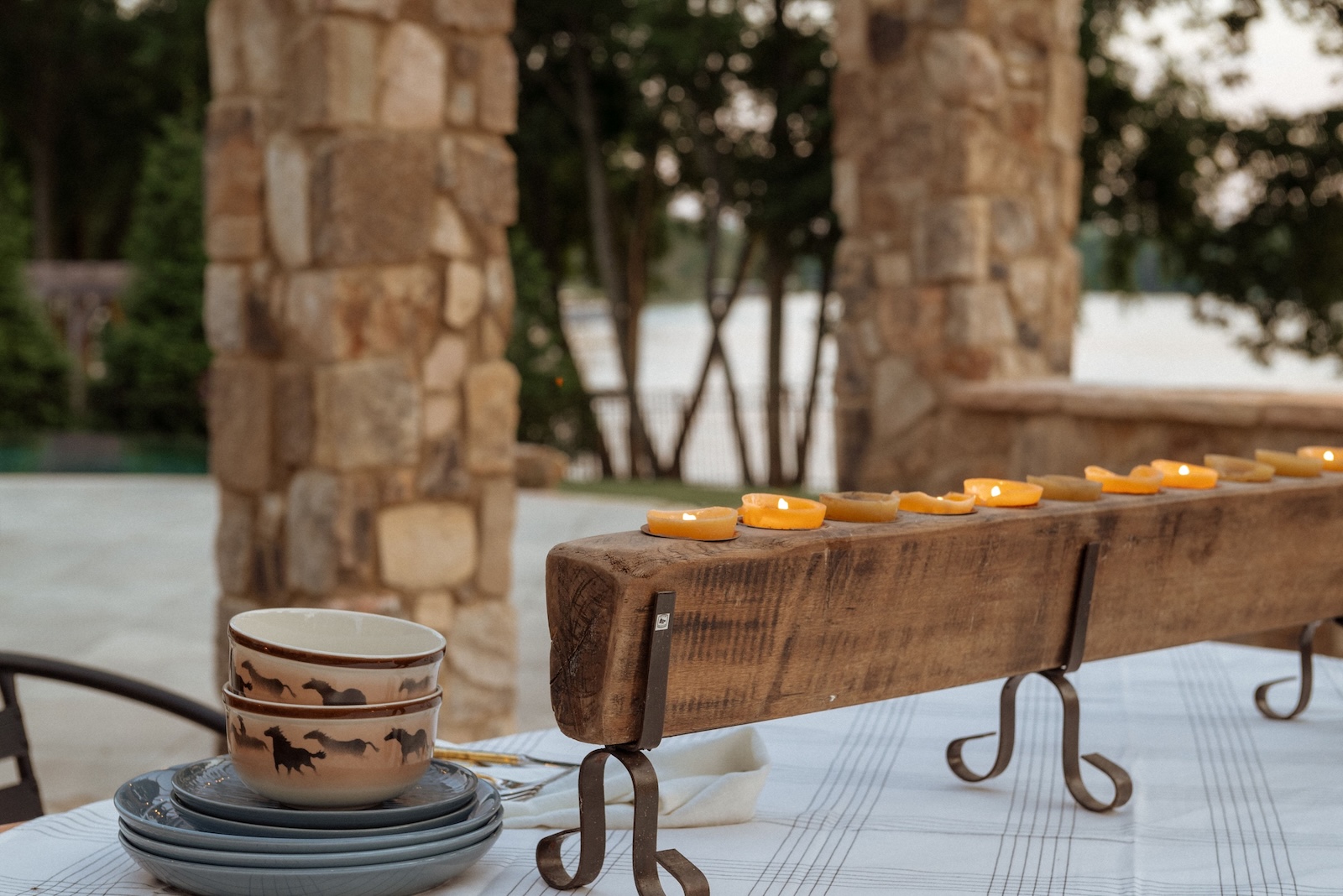 Natural wood candle display tabletop on outdoor table setting | Milosi Nashville Landscaping