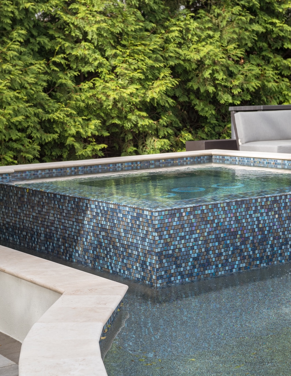 Raised Spa & Custom Pool with Blue Tile, Framed by Ornamental Trees | Milosi Nashville Landscaping