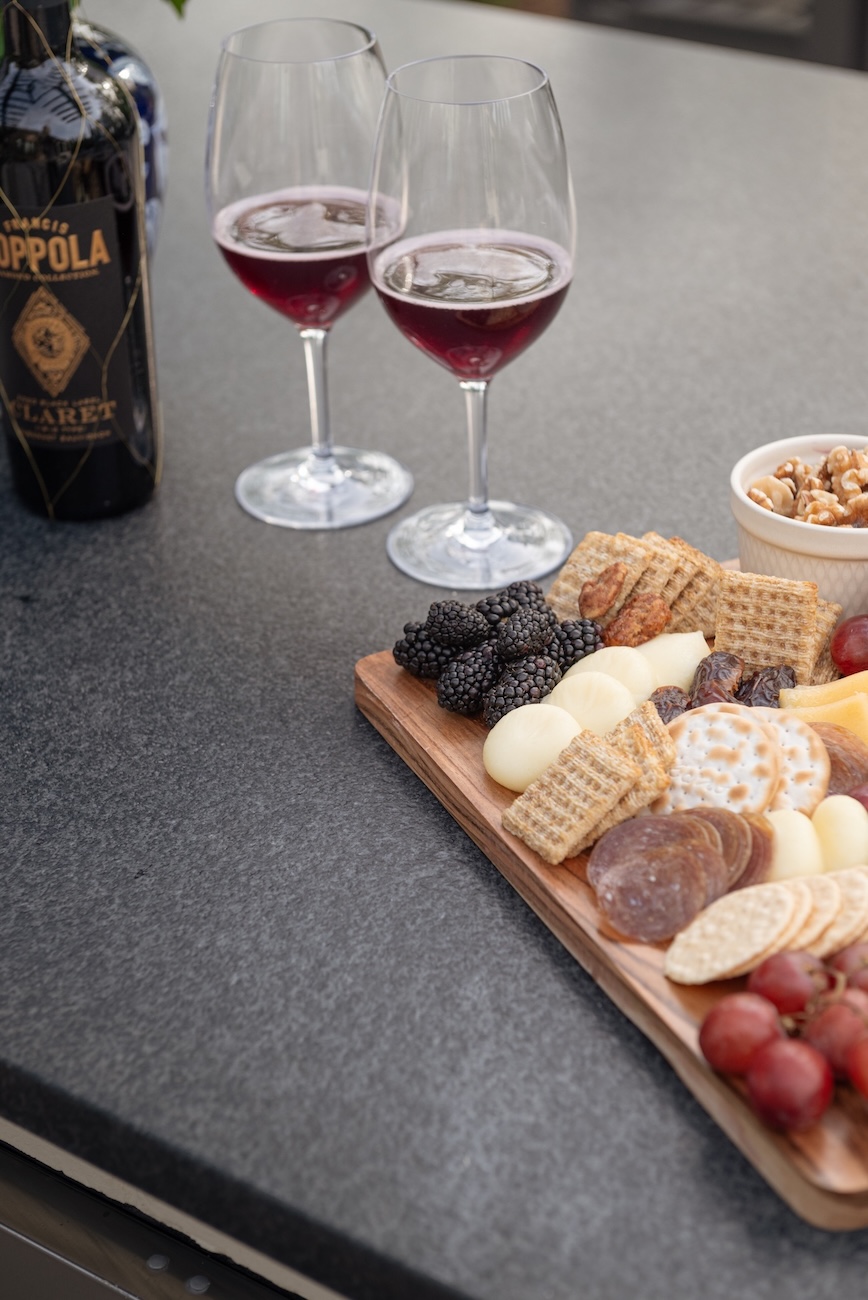 Patio Table with Cheese Board, Red Wine, Two Wine Glasses Half Full | Milosi Nashville Landscaping