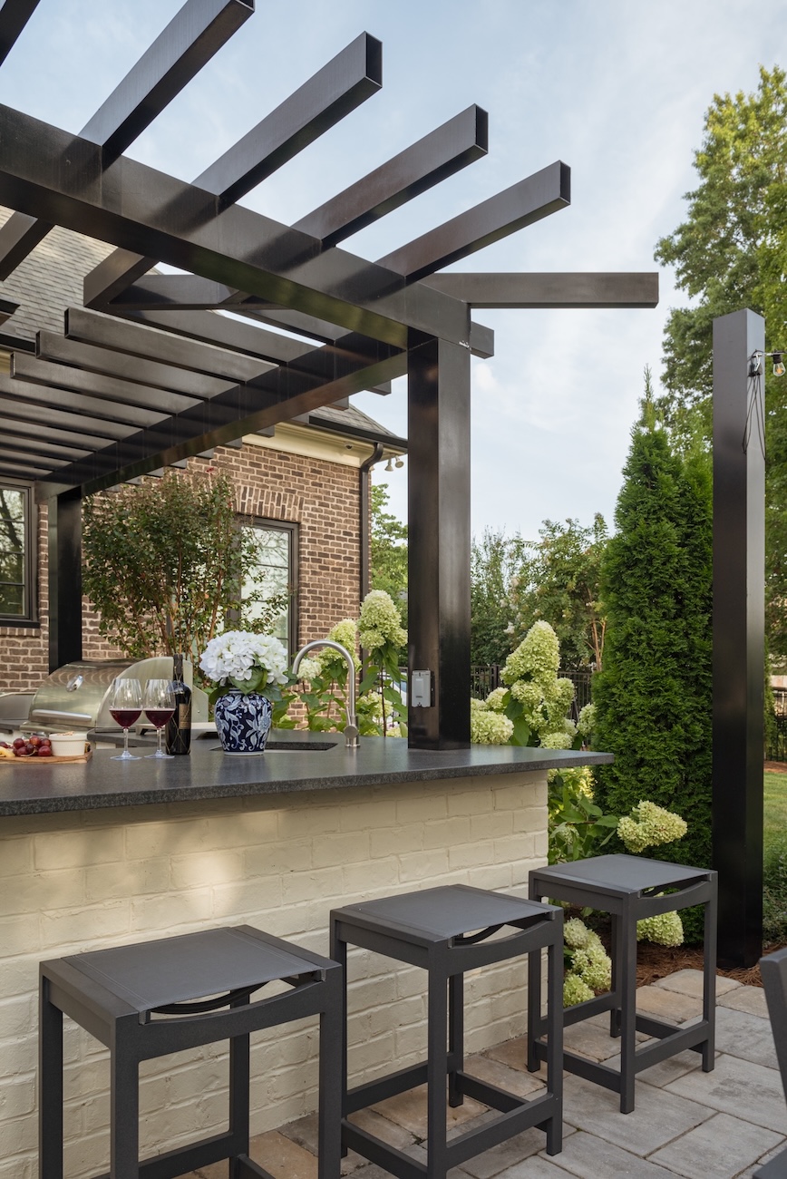 Outdoor Kitchen Bar & Stools with Grill, Sink, Wine & Glasses Under Pergola | Milosi Nashville Landscaping