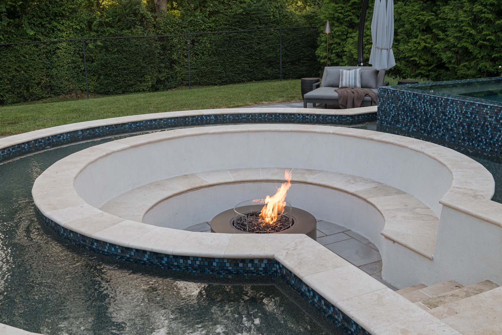 Geometric Fire Pit Circled by Pool, Blue Tile, Lounge Seating, Trees & Fence | Milosi Nashville Landscaping