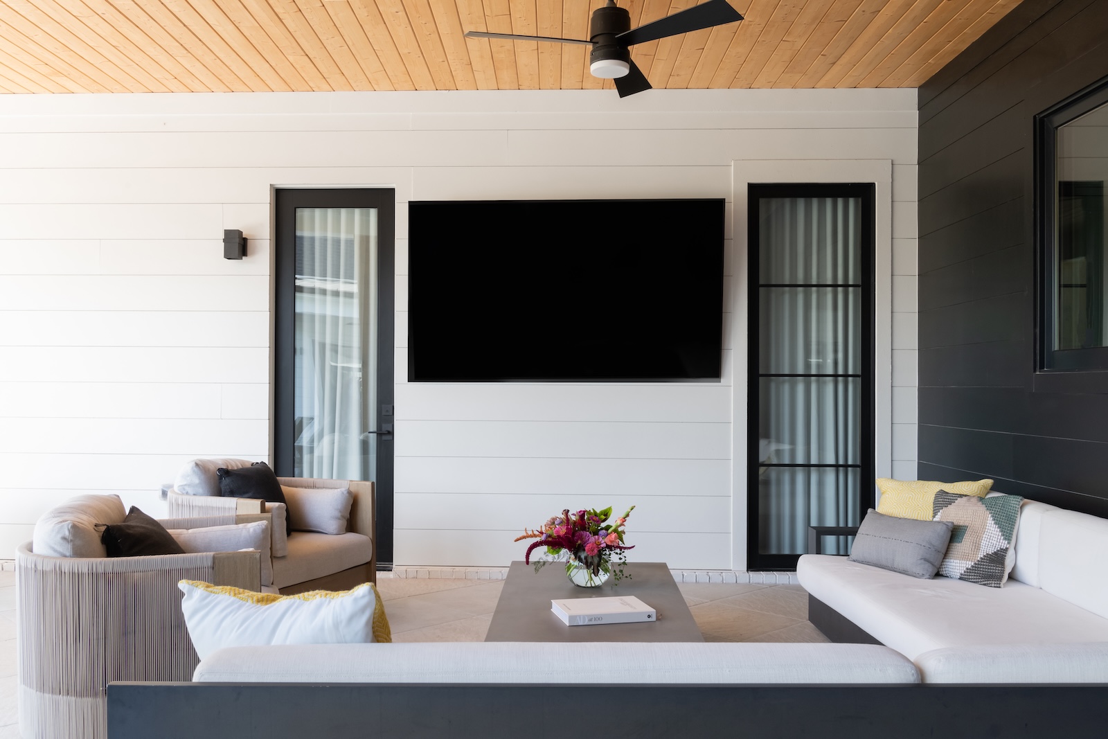 Modern Outdoor Retreat with Flatscreen TV, Glass Patio Door, Custom Furniture | Milosi Nashville Landscaping