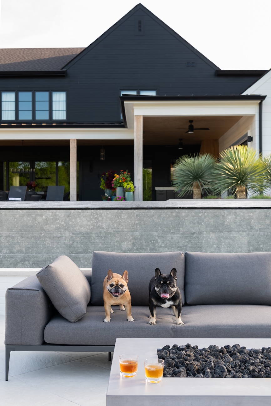 Modern Outdoor Couch with French Bulldogs, Firepit, Drinks, Back Patio View | Milosi Nashville Landscaping