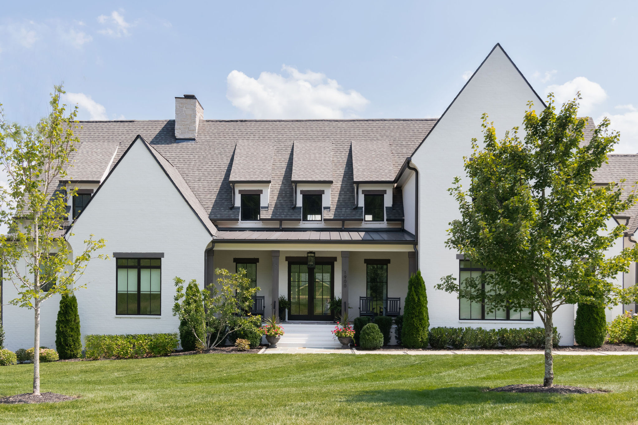 Front view of large white home in Franklin Tn, well landscaped by Milosi Landscaping