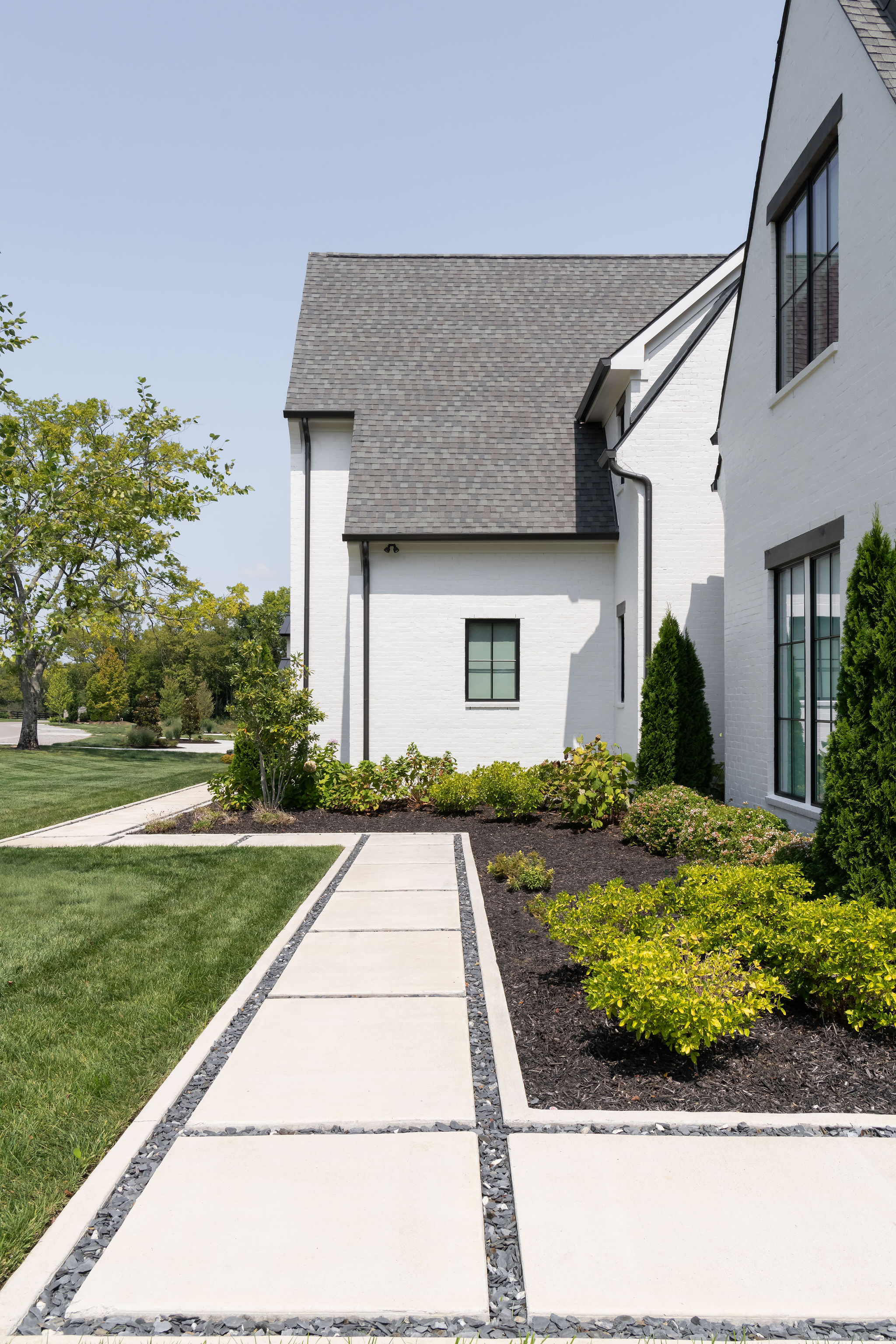 View of cement side walk in front of home in Franklin Tn, built by Milosi Landscapes