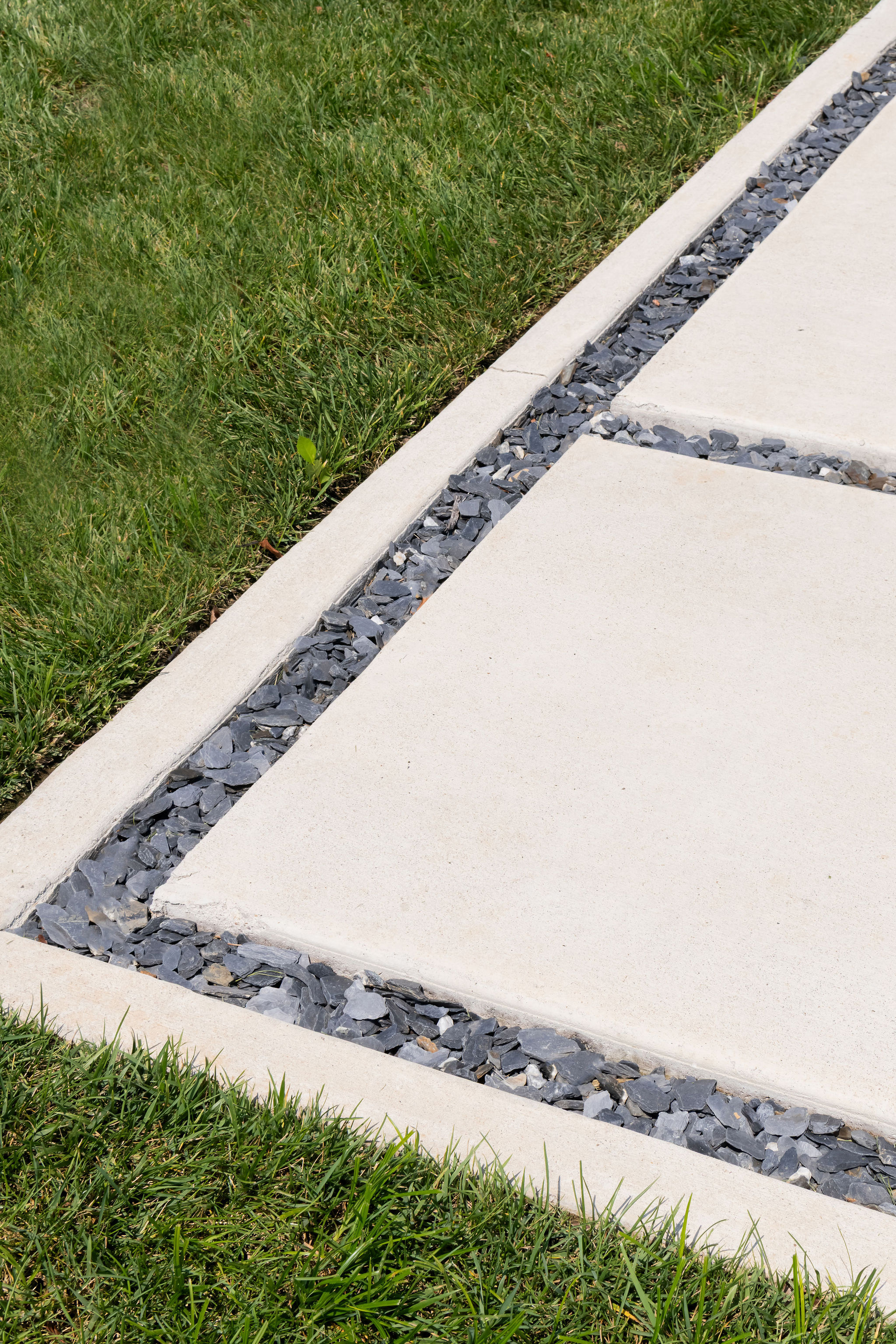 Close up of cement sidewalk showing craftsmanship. Built by Milosi Landscapes.