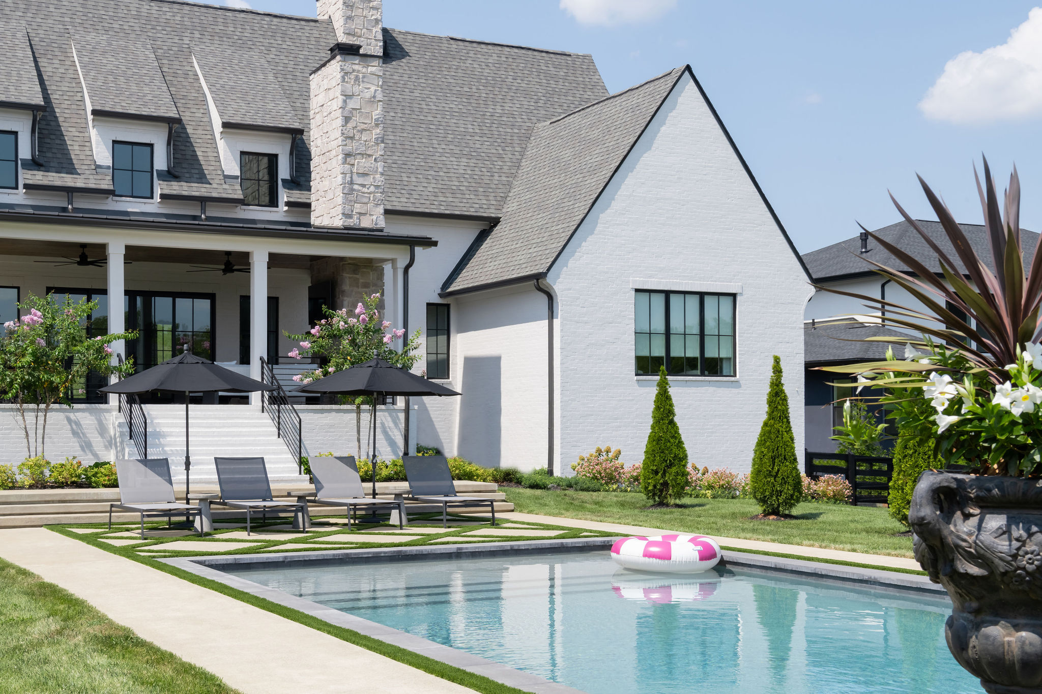 Side view of custom pool with well landscaped walkway by Milosi Landscapes.