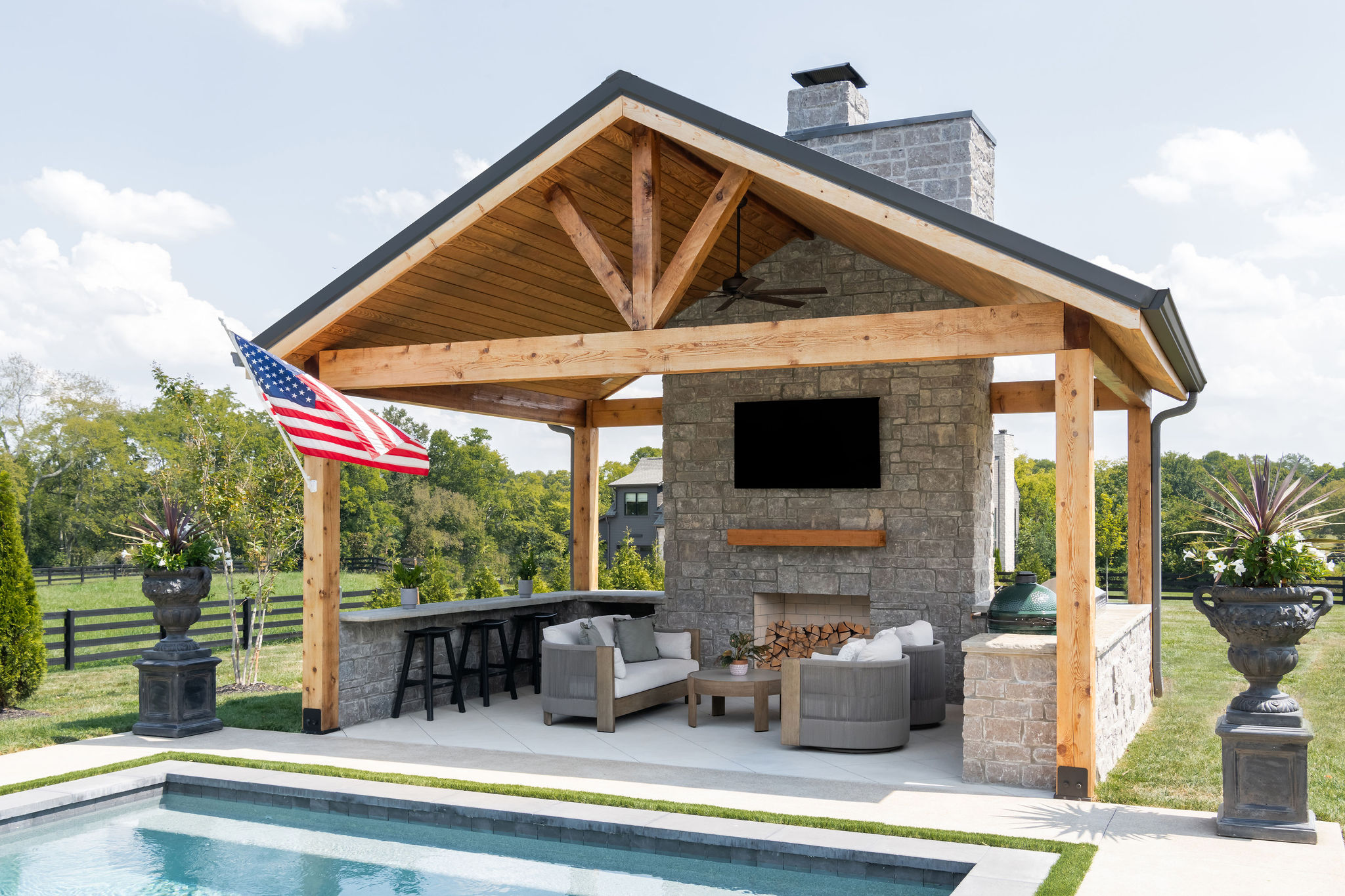 Side view of pool house and patio furniture in the foreground.