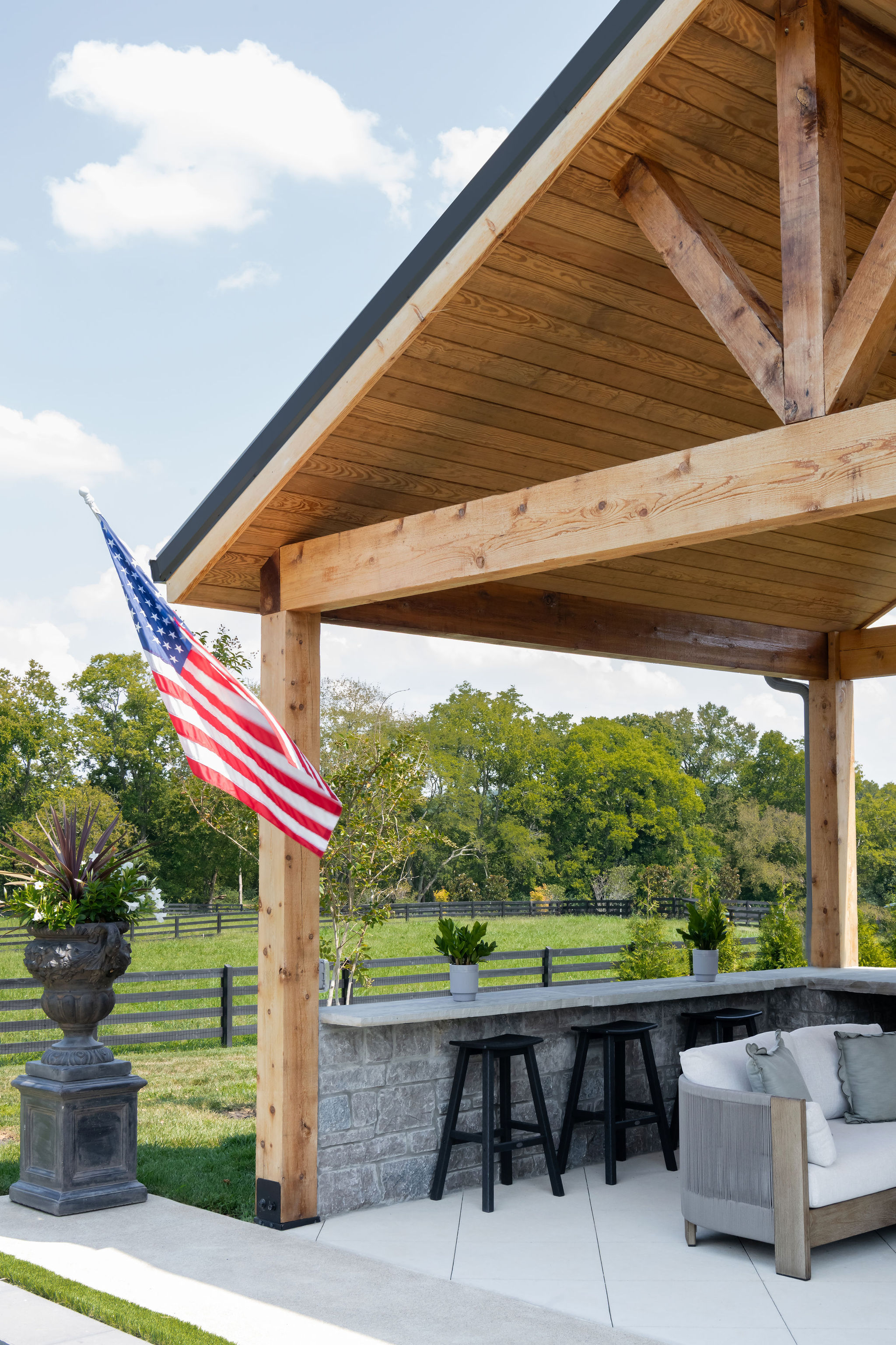 Bar stools in seating area as part of outdoor kitchen built by Milosi Landscapes