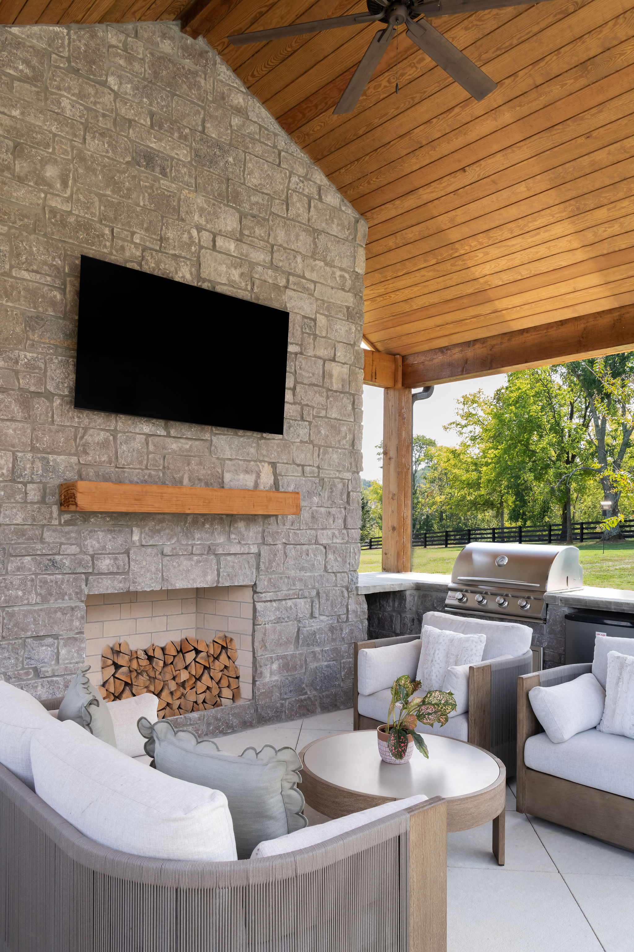 side view of seating area and mounted TV as part of outdoor kitchen built by Milos Landscapes.
