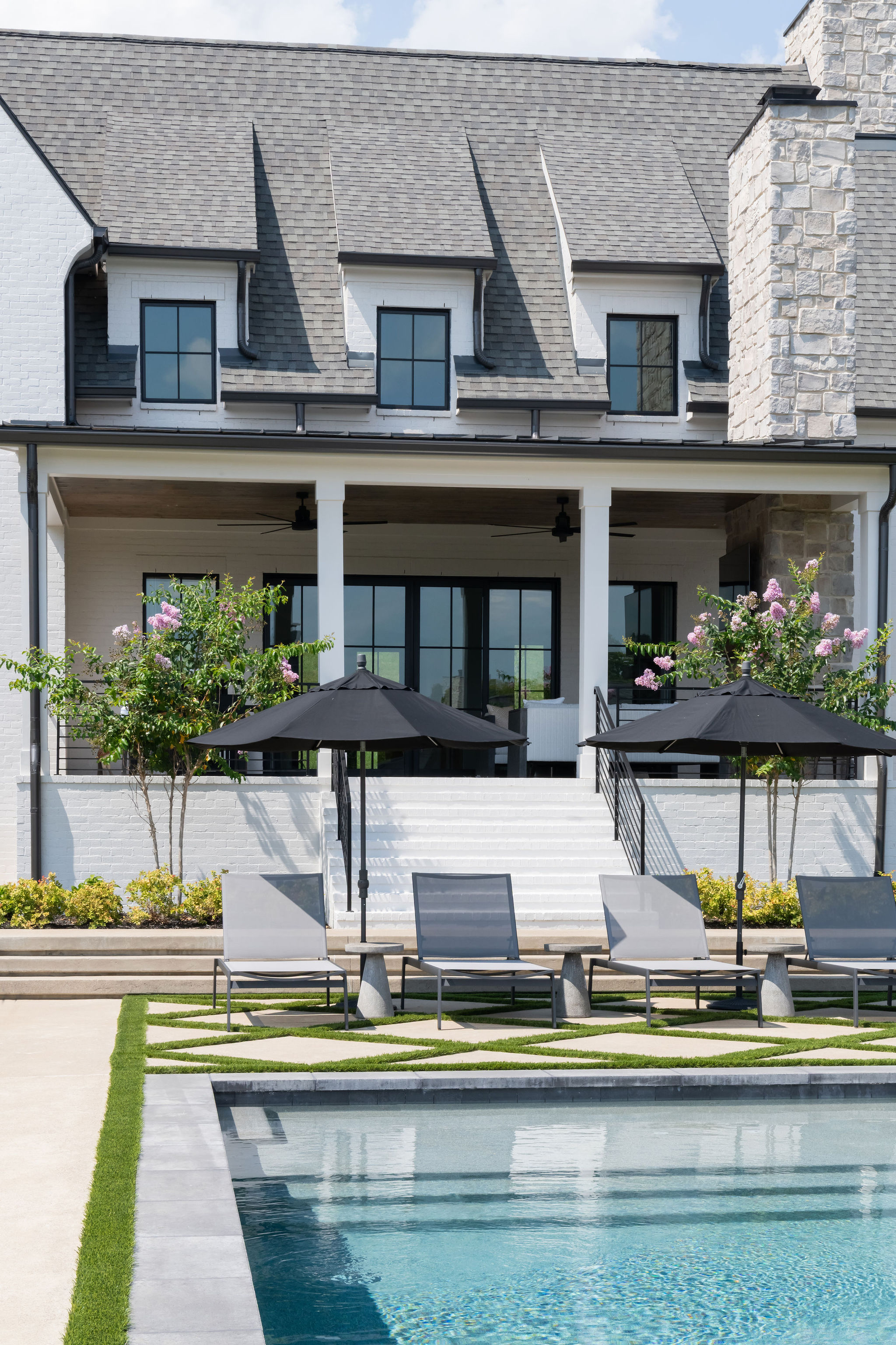 focused picture of the walkway created around the custom pool from Milosi with landscape trees in the background.