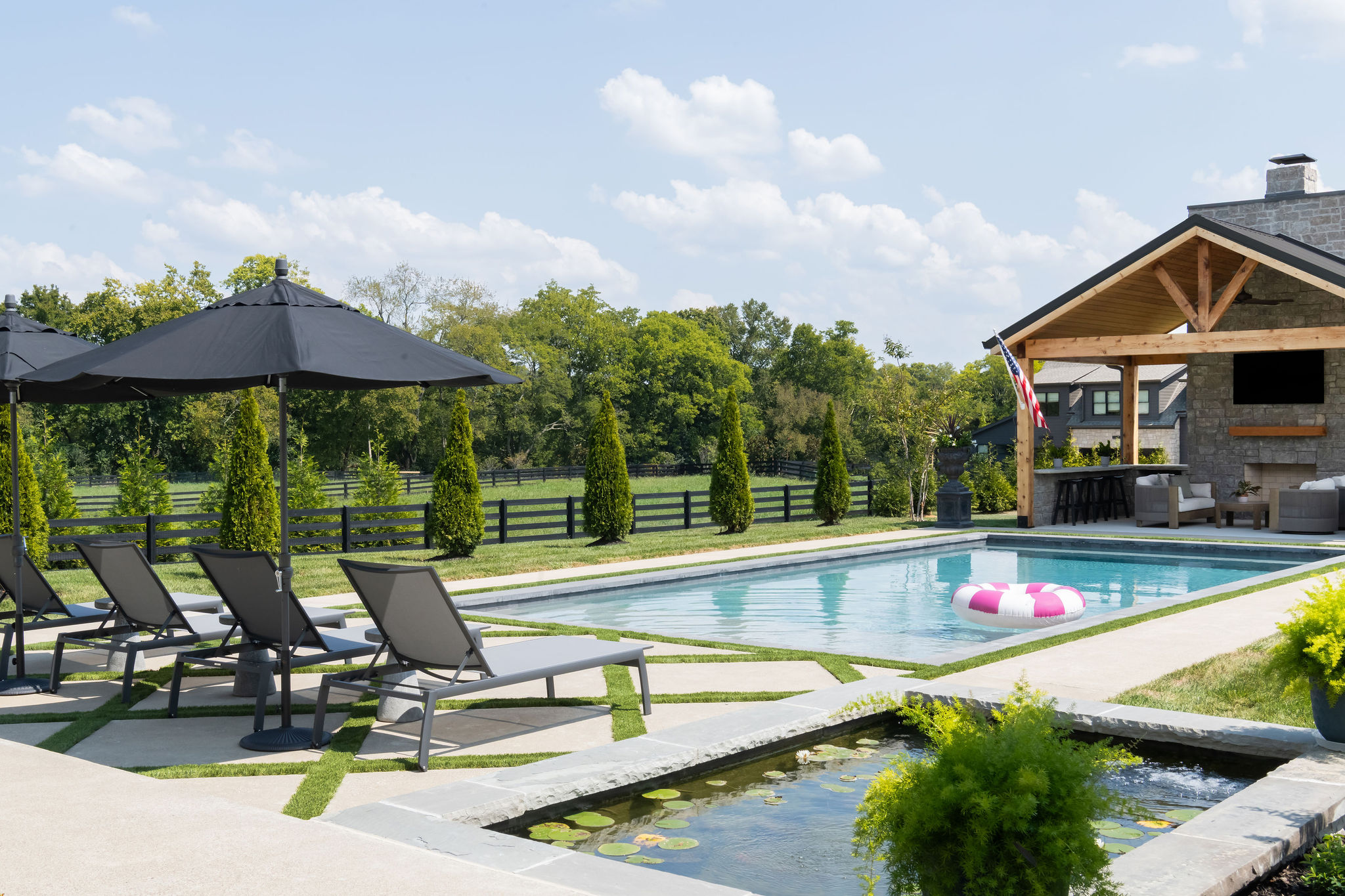 Side view of patio area with custom pool in the background.
